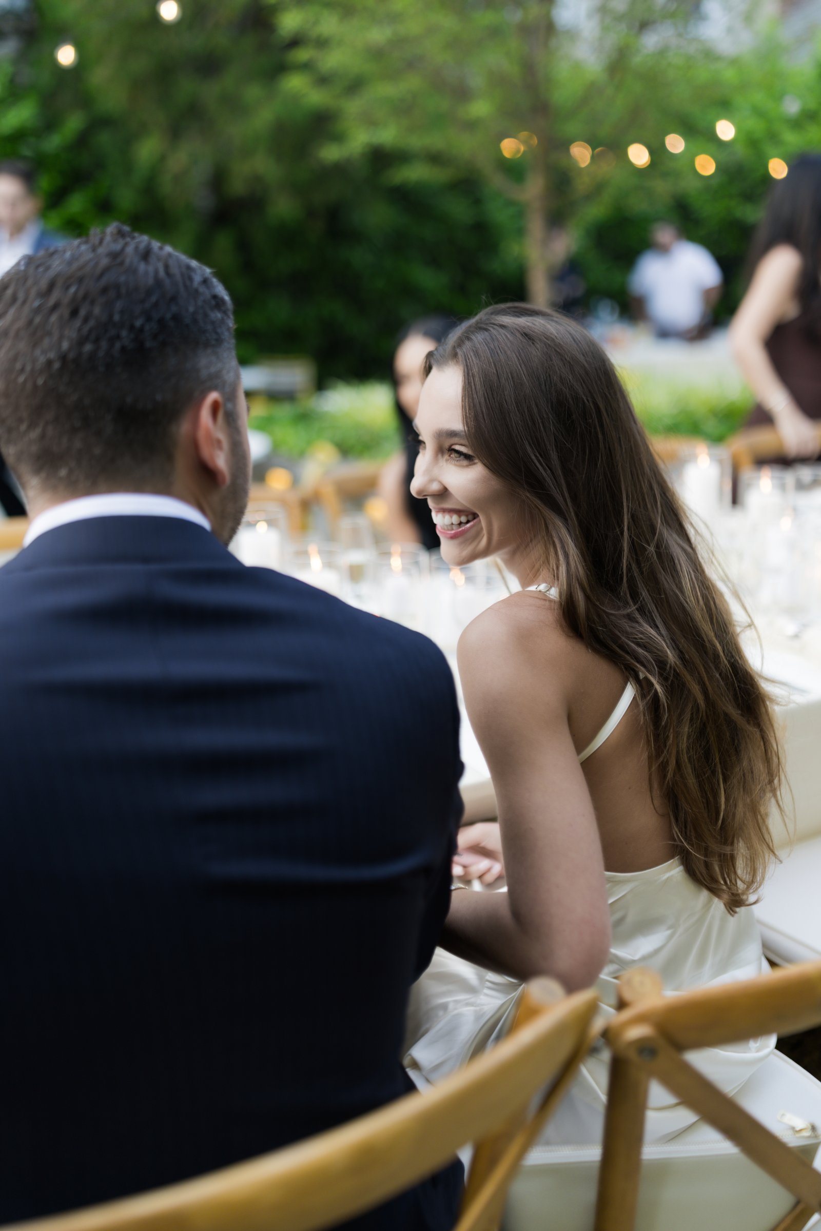Intimate wedding dinner under soft lighting with elegant coastal-inspired décor and intimate seating